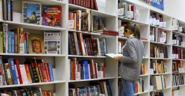 student at library browsing books